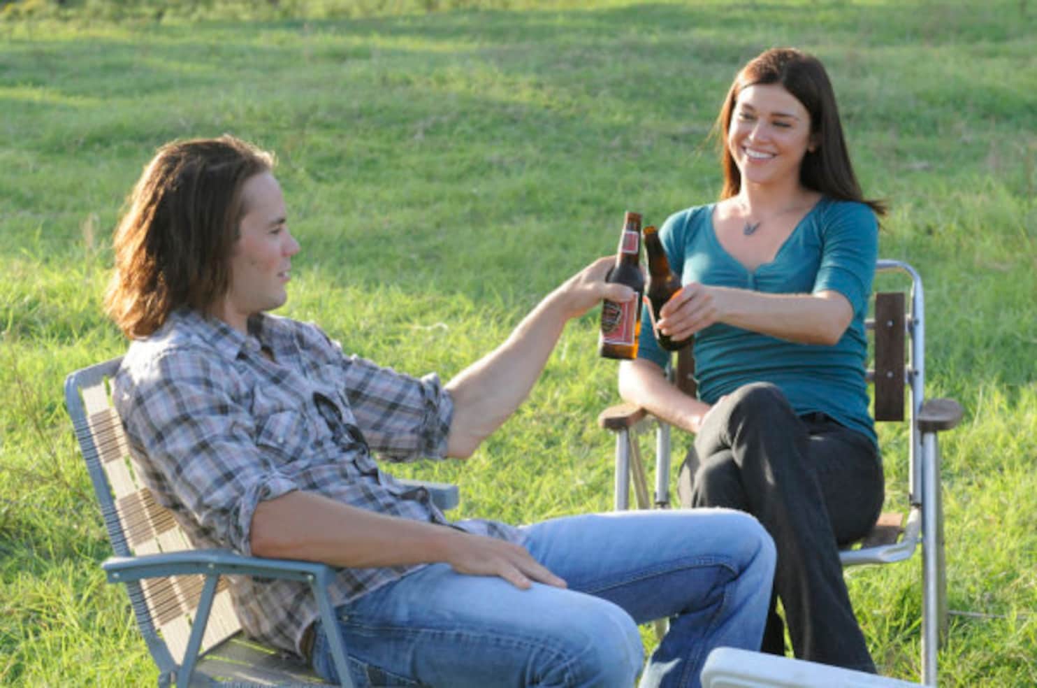 Friday Night Lights shot of Tim and Tyra drinking in a field