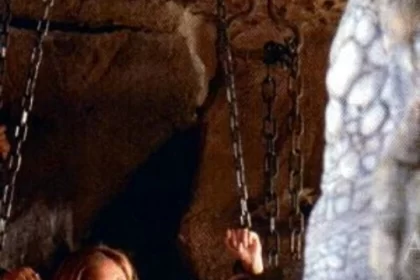 Buffy the vampire slayer still: Buffy chained in a cave with a reptile monster