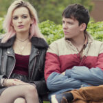 Maeve and Otis from Sex Education sitting on a bench